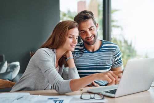 Home, couple and laptop for finance, budget and planning for income, investment and research for life insurance. People, apartment or man with woman, computer and conversation for accounting or email