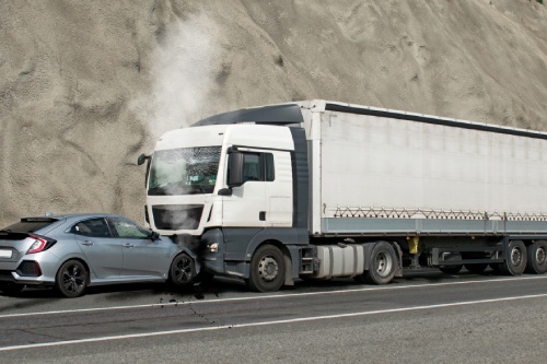 Frontal impact between a car and a truck. Car accident.