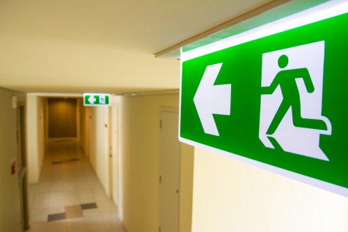 Fire exit sign at the corridor in building