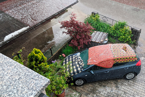 Hailstorm: aerial view from garage of vehicle protected.