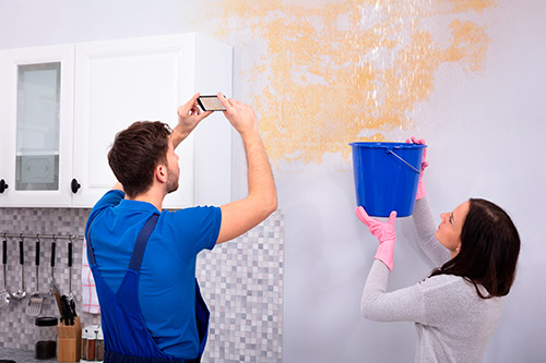 couple doing a wall review for property damage claim
