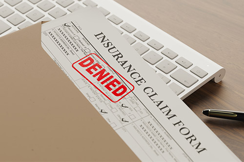A desk with an insurance claim form, emphasizing the need for San Angelo residents to address May 26th storm damage.