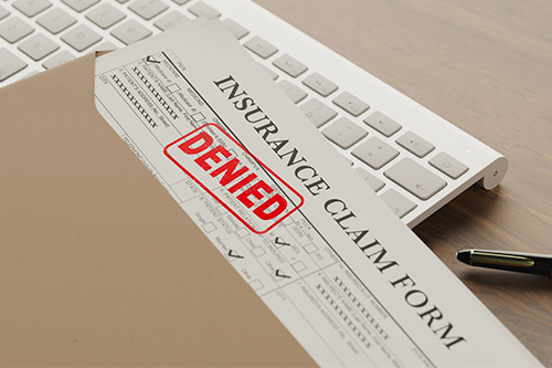 A desk with an insurance claim form, addressing hidden issues from the recent hail damage in Boerne.