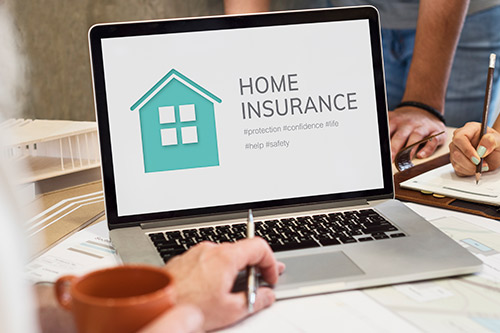Image of a small business owner reviewing home insurance options, highlighting common mistakes in insurance settlements.