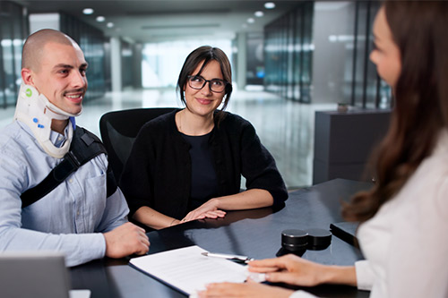 A man and woman collaborate at a desk with a laptop, focusing on selecting the right personal injury lawyer in the Rio Grande Valley.