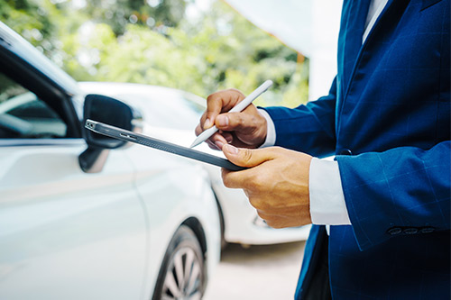 A man in a suit writes on a tablet, emphasizing the importance of safety during Spring Break on Texas highways.