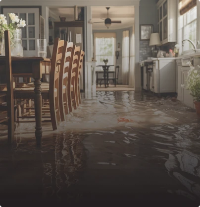 Water-damaged kitchen flooded with chairs and tables placed in the middle of the room.