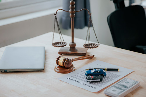 Judge male hand with car and documents and hammer
