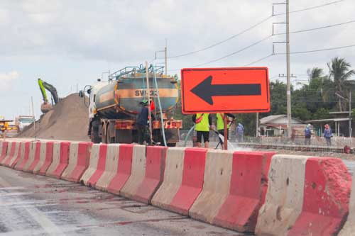 Construction zone, road repairs, sign telling you to turn left. There is construction ahead of the bypass.