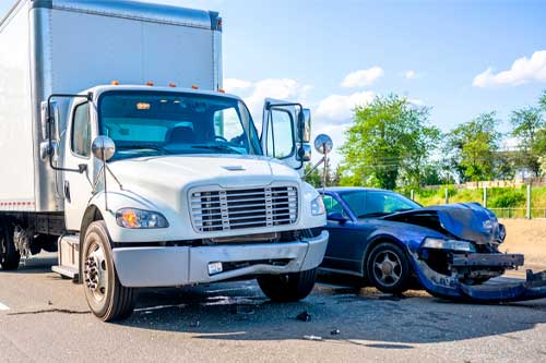 Collision of a semi truck with box trailer a passenger car on the highway road, as a result of which both cars were damaged, await the arrival of the police to draw up an accident report