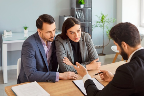 Angry disappointed frustrated stressed couple clients discuss problem with bank manager, demanding explanation of mistake, misunderstanding, change in terms and conditions, customer rights violation